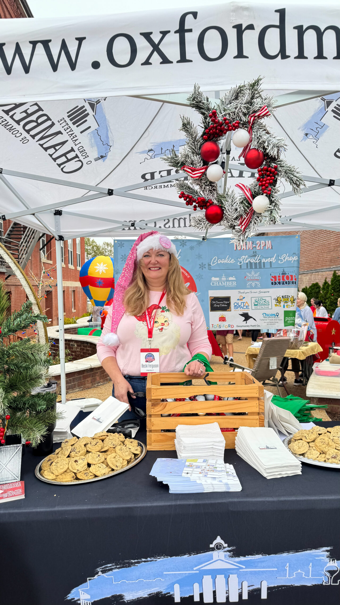 a woman wearing a pink santa hat